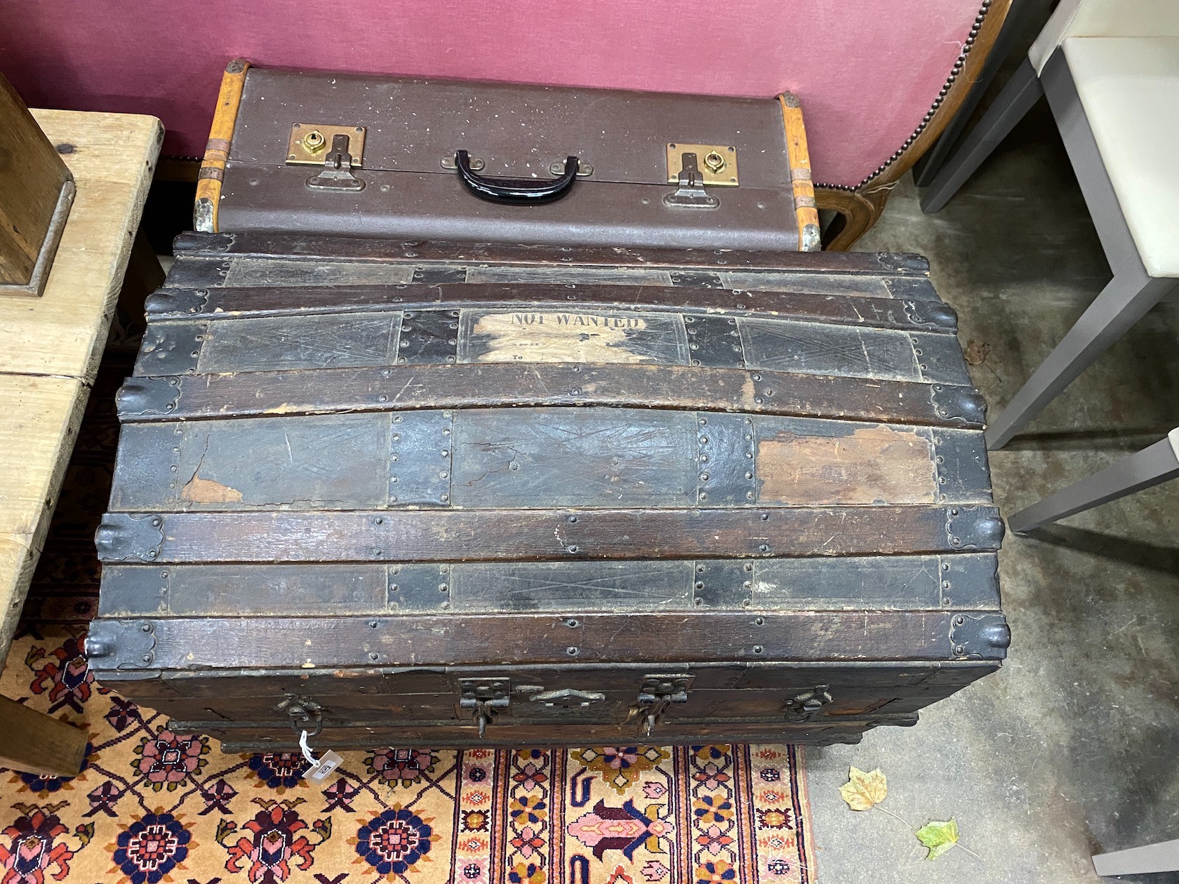 A Victorian wood and iron bound domed trunk, width 78cm, height 54cm, together with a smaller later cabin trunk